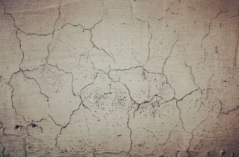 A cracked concrete wall photographed with a 2.35 metre span measured across the crack